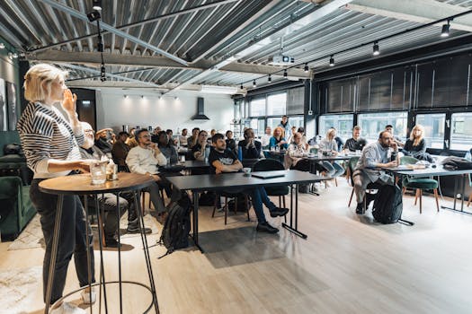 A lively business workshop engaging a diverse audience in a modern conference room.